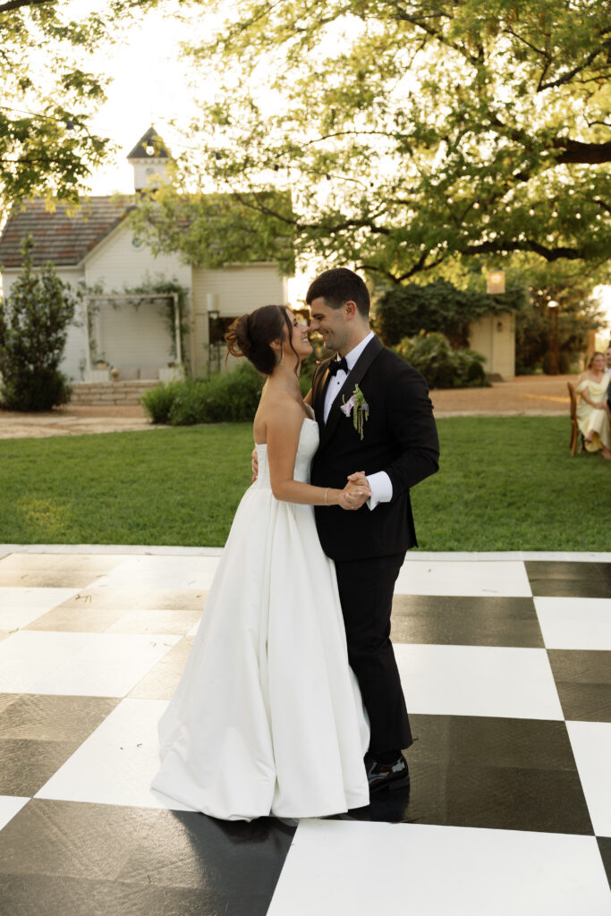 Bride and groom sharing their first dance at an outdoor Austin wedding reception