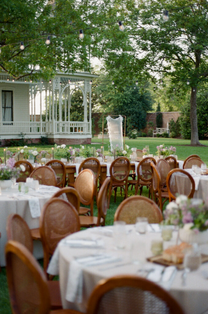 Outdoor wedding reception tables arranged beneath trees at an Austin wedding venue