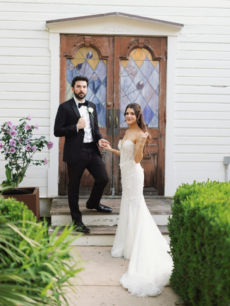 Bride and groom sharing romantic wedding portraits outside Barr Mansion following their ceremony.