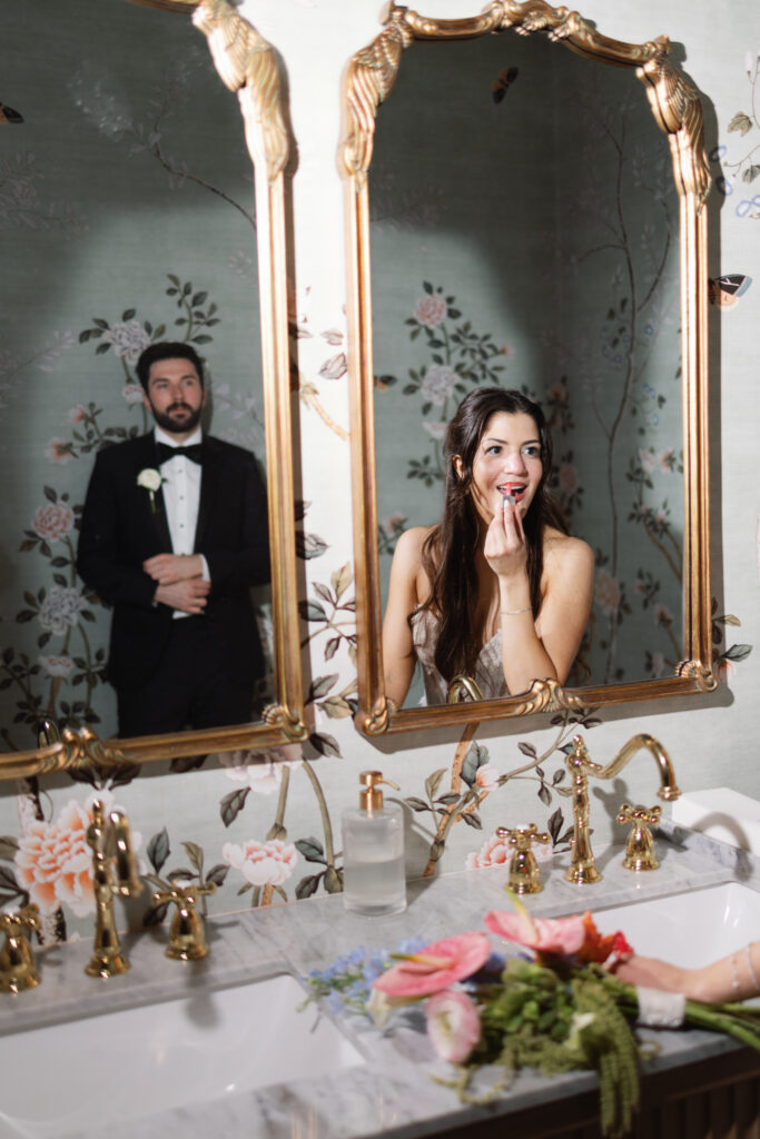 Bride Amanda getting ready while groom Sean waits for their Barr Mansion wedding ceremony.