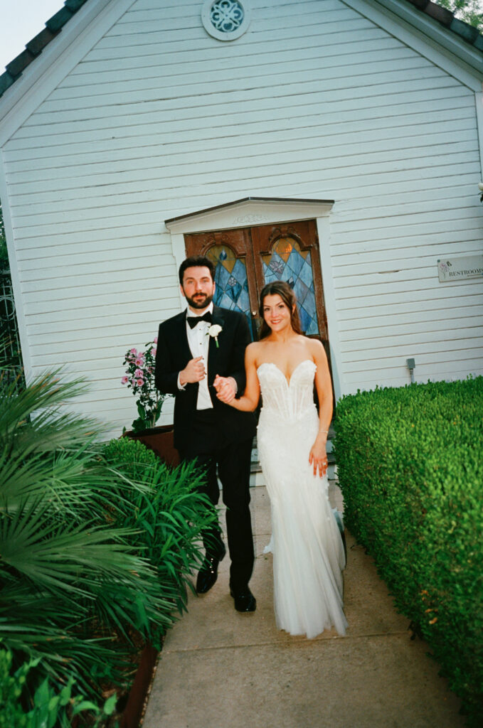 Amanda and Sean walking through the historic grounds of Barr Mansion after their wedding ceremony.