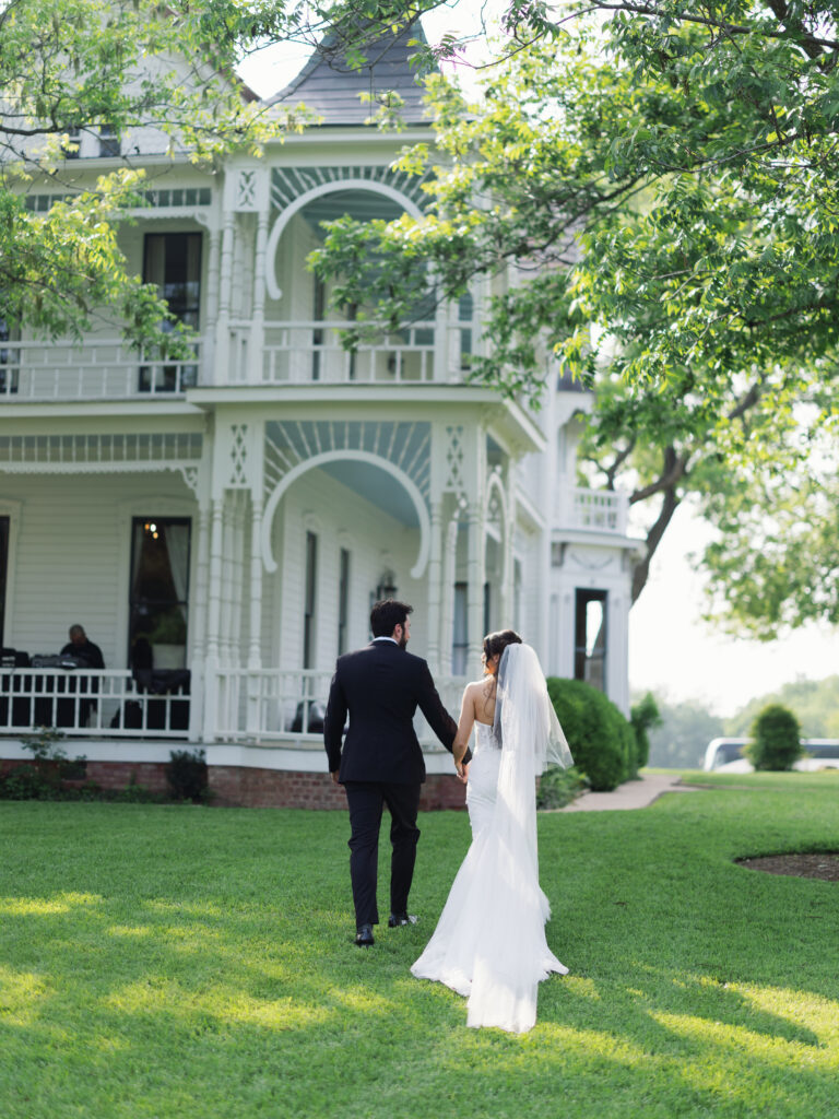 Amanda and Sean celebrating with their wedding party at Barr Mansion in Austin, Texas.