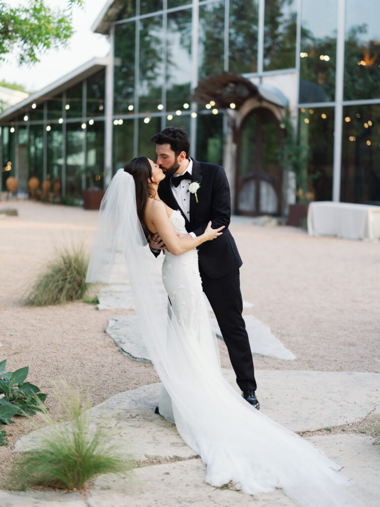Bride and groom sharing romantic wedding portraits outside Barr Mansion following their ceremony.